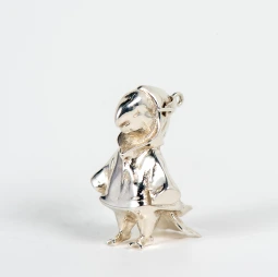 A silver pendant shaped like a parrot in a raincoat