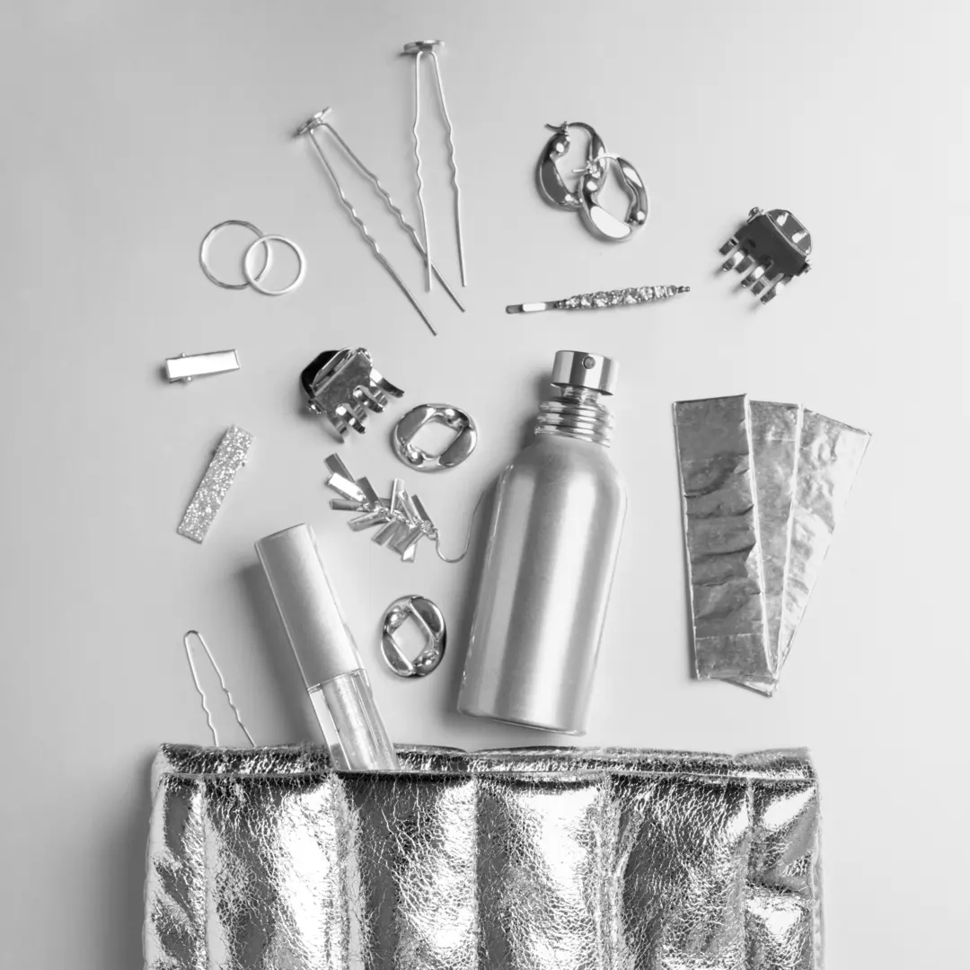A silver pendant shaped like a parrot in a raincoat